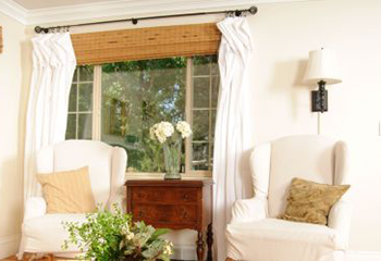 A bright living room adorned with eco-friendly woven wood shades.